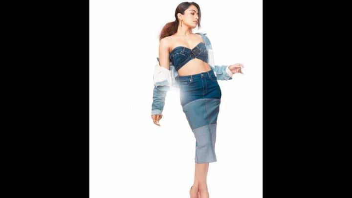 1. Rashmika Mandanna: Rashmika Mandanna looked stunning in a strapless bralette that had a plunging sweetheart neckline. She paired her look with a triple shaded calf length skirt and a matching denim jacket. The actress completed her attire with elegant peach pumps and minimal danglers that gave her a modern look. (Image Source: Twitter/@BtownKi)