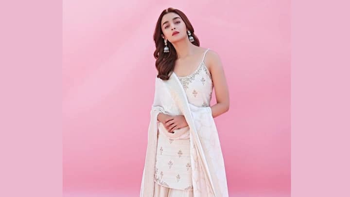 Alia Bhatt's khadi kurta featured strappy shoulder straps and delicate floral motifs, paired with a tulle sharara and a matching khadi dupatta. She completes the look with silver kolhapuris, making it a perfect choice for a family puja. (Image Source: Instagram/ aliaabhatt)