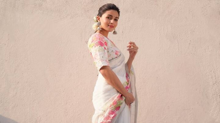 In another ethereal saree look, Alia opted for a breezy white saree that features embroidered floral motifs in pastel green, pink, and blue. Paired with a white spaghetti-strap blouse, she showcased how white sarees can be both soft and striking. (Image Source: Instagram/ aliaabhatt)