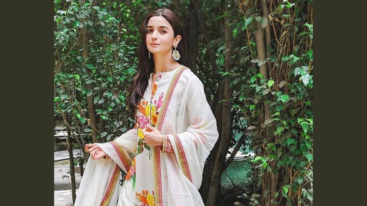 Her cotton sharara set adorned with large, colourful floral prints looks elegant. She paired it with a cotton dupatta that features a pink and golden border, making the ideal ensemble for a puja at home. (Image Source: Instagram/ aliaabhatt)
