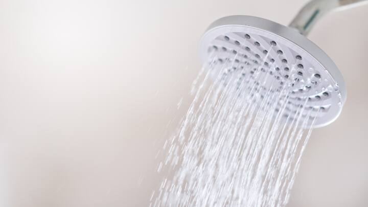 Avoid prolonged and hot showers. (Image Source: Canva)