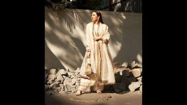 4. Karisma Kapoor: Karisma Kapoor looked stunning in a white Anarkali suit set. Her traditional attire featured matching palazzos and a dupatta. The delicate net attire had gold embroidery all over it along with elegant gold borders. (Image Source: Instagram/@therealkarismakapoor)