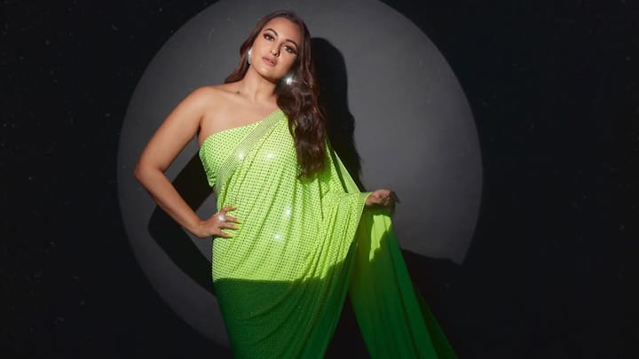 Sonakshi Sharma dressed to impress in a vibrant neon green saree with crystal embellishments, paired up with a daring one-shoulder blouse. The body-hugging, bold hue and shimmering details made her look effortlessly glamorous for any occasion. (Image Source: Instagram/ aslisona)