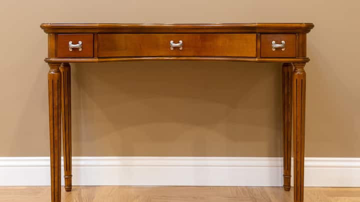 7. Add a Wooden Console Table: A narrow wooden console table is perfect for putting against the wall and decorating a room with lamps, photos and winter themed ornaments. (Image Source: Canva)