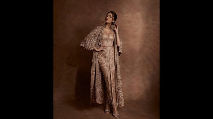 3. Tara Sutaria: Tara Sutaria mesmerised in a fusion attire that featured a corset blouse with a sweetheart neckline and gold embroidery. The actress paired her outfit with a pre draped bottom that created a striking look. Her all gold outfit made her radiate charm. (Image Source: Instagram/@tarasutaria)