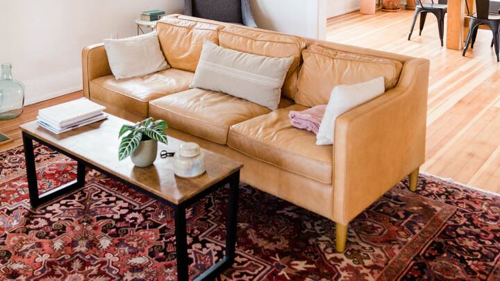 3. Layer Rugs for Extra Comfort: In the cooler months, timber flooring can be quite chilling which is why I recommend layering some beautifully designed rugs, starting with a neutral colored softer rug and then layering with a smaller bold patterned rug. Besides adding a bit of color these nicely designed rugs also provide additional warmth to your interior. (Image Source: Canva)
