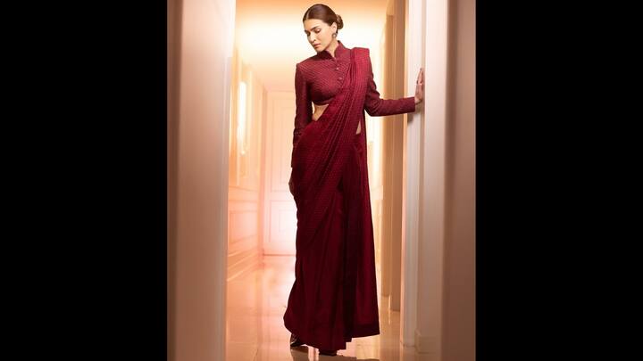 5. Kriti Sanon: Kriti gave her traditional saree a formal vibe with her blouse choice. Her blouse featured a collared high neck, long sleeves, and front buttons. The monochromatic look exuded bold elegance. Kriti Sanon completed her beautifully draped saree with minimal jewellery that gave her a touch of sophistication. (Image Source: Instagram/@kritisanon)