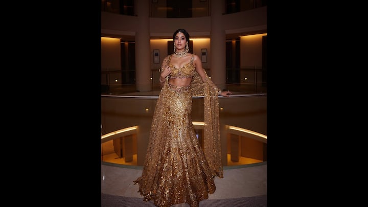 4. Janhvi Kapoor: Janhvi looked flawless in a traditional gold outfit. Her attire featured a heavily embellished blouse that she adorned with gold jewellery, emeralds, and ruby stones. She paired it with a matching lehenga and dupatta that gave her a regal charm. (Image Source: Instagram/@janhvikapoor)
