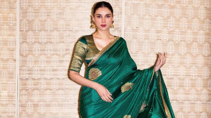 Aditi Rao Hydari takes forward the ethnic charm in a traditional green saree, accessorising with golden jhumkas and a sleek bun accentuated with a white gajra. Soft makeup, a black bindi, and peach eyeshadow complete this exquisite attire-outfit, perfect for celebrating Mahashivratri.  (Image Source: Instagram/ aditiraohydari)
