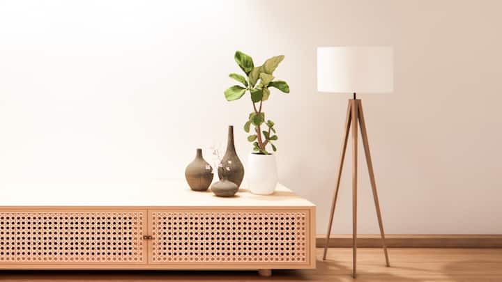 2. Go for a Statement Wooden Lamp: A unique touch in styling that can be executed is a wooden base lamp, this lamp can feature a fabric shade that enhances the rustic feel, while spotlighting the wooden structure. A wooden table lamp or a floor lamp can be utilized to provide the room with an inviting warmth. (Image Source: Canva)