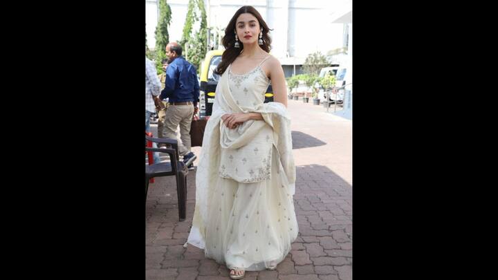 8. White Sharara Set: Alia Bhatt stuns in a breathtaking white sharara set that symbolises peace and purity. She has paired her sleeveless kurta with a delicate sharara and matching dupatta which has intricate embroidery. To complete her traditional look, she accessorised herself with statement earrings that added a touch of glamour. (Image Source: Pinterest/aliabhatt0684)