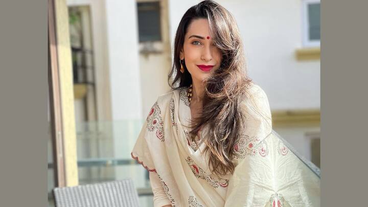 Ivory Silk Anarkali With Red Polka Dots: This ankle-length ivory silk Anarkali with three-quarter sleeves had fine red polka dots and ended with resham cutwork on the hemline. It was styled with ivory silk cigarette pants and a printed dupatta that featured red cutwork, making the statement subtle yet strong. (Image Source: Instagram/ therealkarismakapoor)
