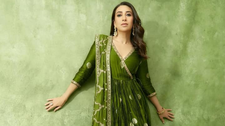 Green Satin Anarkali: Karisma looked stunning in this green satin Anarkali with silver zari borders and intricate resham thread embroidery.The long sleeves and plunging neckline made it modern, whereas the pleated skirt paired with the ethnic patchwork pants rounded off the look for the festive occasion. (Image Source: Instagram/ therealkarismakapoor)