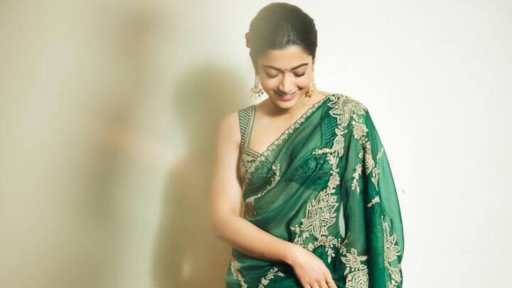 She redefined opulence in this forest green saree enriched with golden floral embroidery. The rich hue stood out against the season's pastels, making a bold and regal statement. (Image Source: Instagram/ rashmika_mandanna)