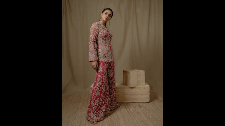8. Traditional Co-Ord Set: Keerthy Suresh wore a traditional pink coloured co-ord set. The outfit was heavily embellished and embroidered giving it a charming look. The fitted silhouette featured full sleeves along with flared pants. The actress completed her attire with bold contrasting earrings and a statement ring. (Image Source: Instagram/keerthysureshofficial)