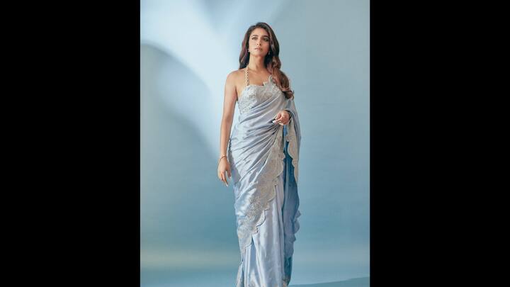 6. Pastel Blue Saree: Keerthy wore a pastel blue saree that had silver embroidery and embellishments all over it that gave it a graceful look. The halter neck blouse added a modern touch to the saree. The actress wore minimal gold jewellery with her delicate saree that gave her an ethereal look. (Image Source: Instagram/keerthysureshofficial)