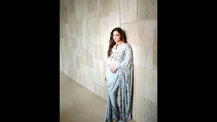 7. Black And White Saree: Tamannaah Bhatia embraced modern elegance in her black and white saree. The white saree had black beaded details all over it that gave it a contemporary charm. The actress paired her saree with a sleeveless blouse that featured heavy beaded detailing and a plunging neckline. She wore a statement choker neckpiece with her saree for a unique touch. (Image Source: Instagram/@tamannaahspeaks_)