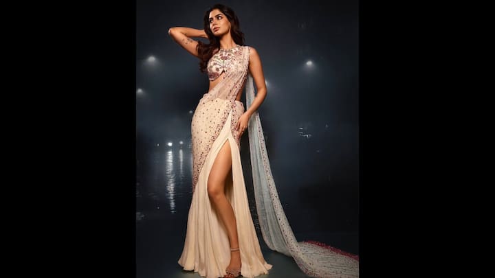 4. White Embellished Outfit: Khushi Kapoor wore an intricately embellished white outfit that had a thigh high slit. Her outfit had a sheer drape and floral designs that she paired with a fitted blouse. The actress's outfit had sparkling detailings that gave her a graceful and glamorous look. (Image Source: Instagram/@khushikapoor)