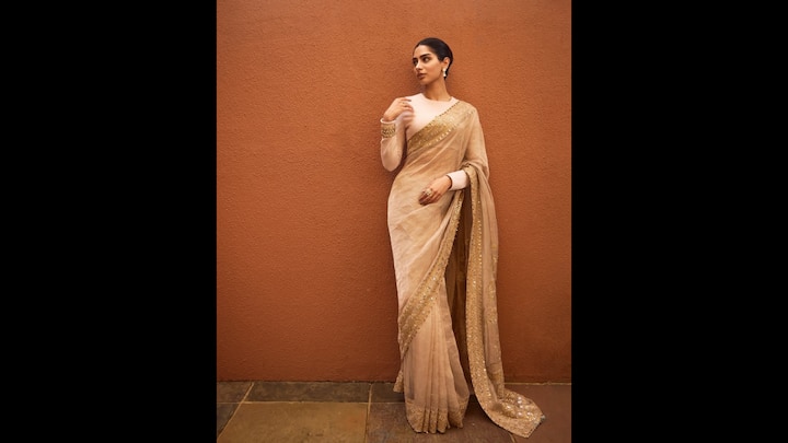 8. Gold Saree: Khushi Kapoor's gold saree had a sheer fabric that gave it a delicate look. The saree had beautiful gota patti detailing all over the borders. She wore a simple full sleeves blouse with her saree. The actress paired her traditional look with minimal jewellery. (Image Source: Instagram/@khushikapoor)