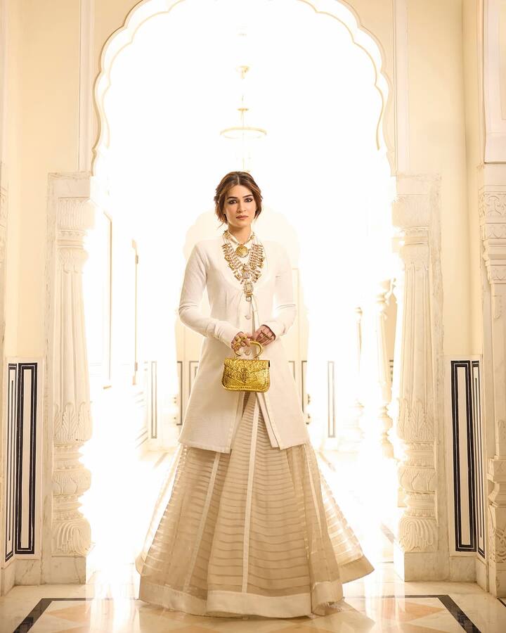 Her outfit featured a long ivory kurta with a buttoned front paired with a sheer lehenga skirt.