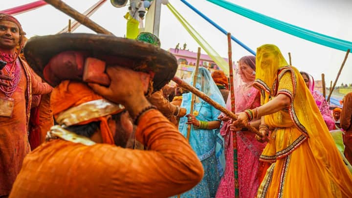 The festival is primarily observed in Barsana and Nandgaon, the respective villages of Radha and Krishna. On the first day, men from Nandgaon visit Barsana, and on the second day, the men from Barsana visit Nandgaon for a colourful Holi celebration | Photo: IANS