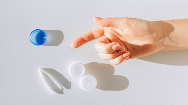 2. Remove contact lenses (if applicable): Take out your contact lenses to prevent the colour from getting trapped underneath. (Image Source: Canva)