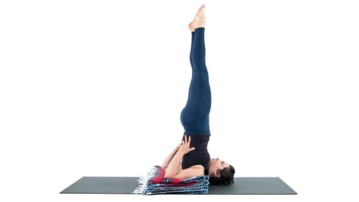 3. Shoulder Stand (Sarvangasana): Shoulder Stand is a great yoga pose to balance the hormones. It also helps in enhancing thyroid function. The pose improves metabolism, calms the mind, and reduces stress. It helps in strengthening the core, toning the pelvic muscles, and alleviating menstrual discomfort. (Image Source: Pinterest/YogaUOnline2)