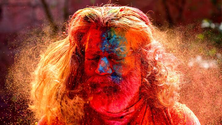 Bikaner: A tourist takes part in Holi celebrations in Bikaner. (Image Source: PTI Images)
