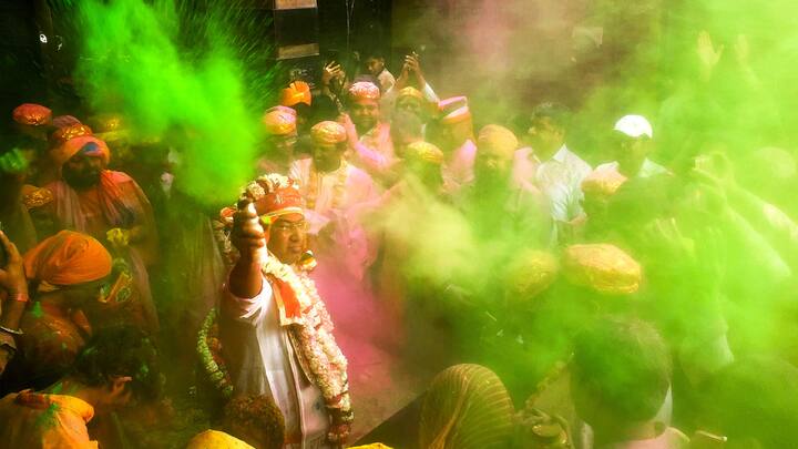 Agra: Devotees participate in a 'Rang Yatra' taken out from Mankameshwar Mahadev temple. (Image Source: PTI Images)