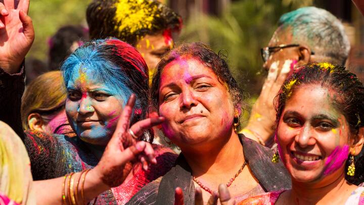 Ghaziabad: Women pose for pictures while celebrating Holi. (Image Source: PTI Images)