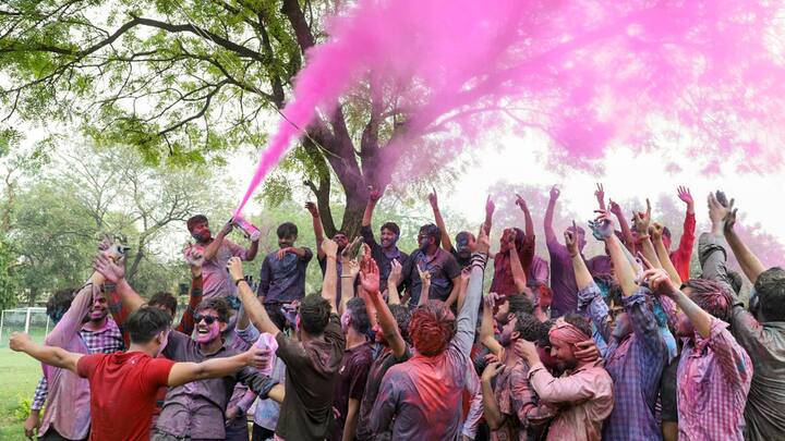 Aligarh: Students dance as they celebrate Holi with colours at Aligarh Muslim University. (Image Source: PTI Images)