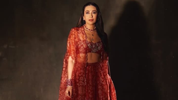 Karisma embraced festive grandeur in this mesmerising red lehenga, paired with a flowing shrug for a regal appeal. The floral embroidery on the bralette added intricate detail, while the flowy skirt and cape created an ethereal silhouette, making it a perfect pick for a traditional celebration. (Image Source: Instagram/ therealkarismakapoor)