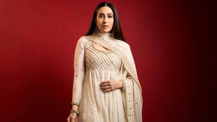 Channelling old-world charm, Karisma looks regal draped in a pearl-white anarkali suit, revering the heritage craftsmanship. The suave, intricate golden work does due favours to the flowing silhouette; perfect for a classic, refined ethnic appeal. (Image Source: Instagram/ therealkarismakapoor)