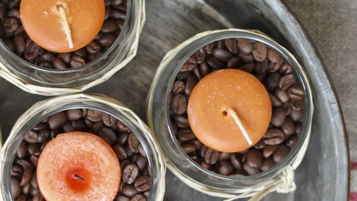 8. Coffee Bean Centerpiece: Fill a bowl with coffee beans and place small tea lights in the center. The warmth of the candles will release a rich coffee scent that will eliminate unwanted odours. It will give your home a cosy and inviting vibe. (Image Source: Pinterest/goodhousemag)