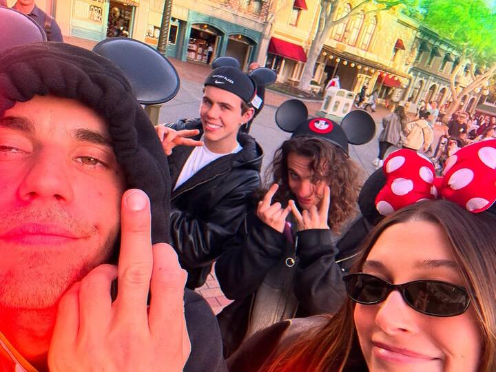 Two selfies featured the couple wearing Mickey and Minnie Mouse ears, looking happy in Disneyland’s Main Street, U.S.A.