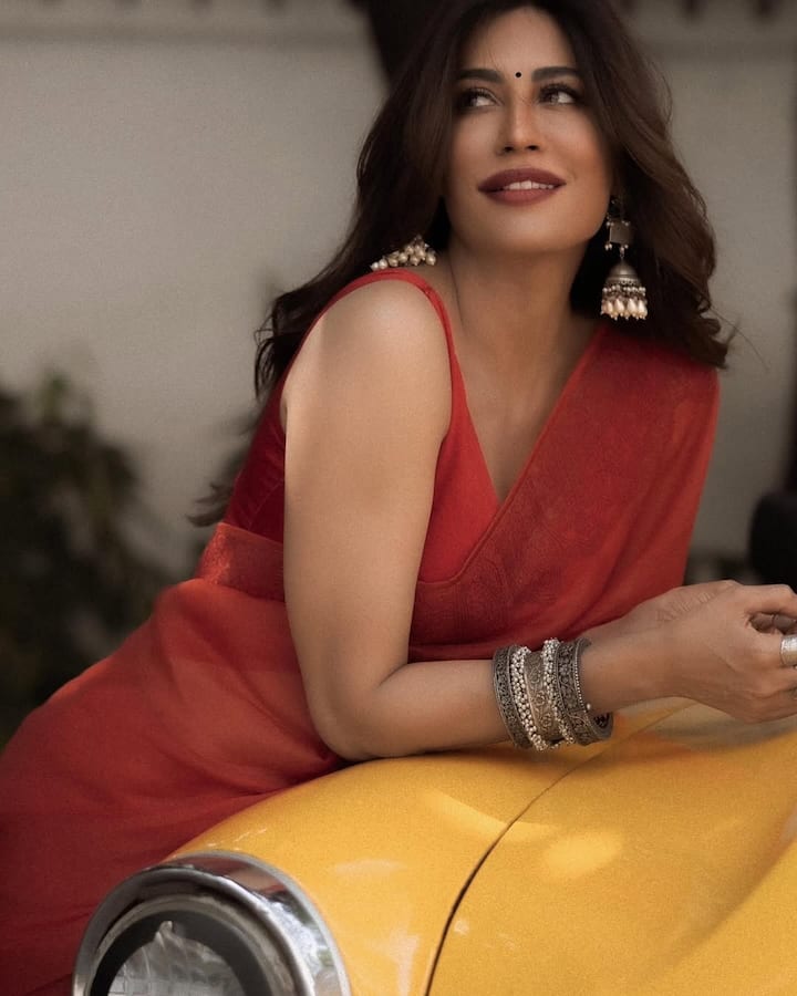 With tousled waves cascading down her shoulders, Chitrangda exudes an effortless, natural charm. The warm, earthy tones of the background, coupled with her relaxed yet poised expressions, create a visually captivating aesthetic.