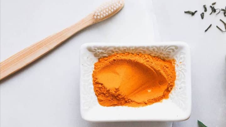 8. Turmeric Powder: Turmeric has anti-inflammatory properties that improves gum health while whitening the teeth. It's also known for its anti bacterial properties as well. Brush your teeth with a small amount of turmeric powder which will help remove the stains and enhance oral health. (Image Source: Pinterest/helloglowblog)