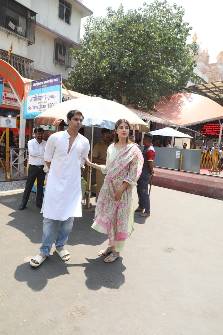 Rhea chose a green and pink floral suit for the visit, while Showik was dressed in a white kurta paired with denim jeans.  (Image: Manav Manglani)