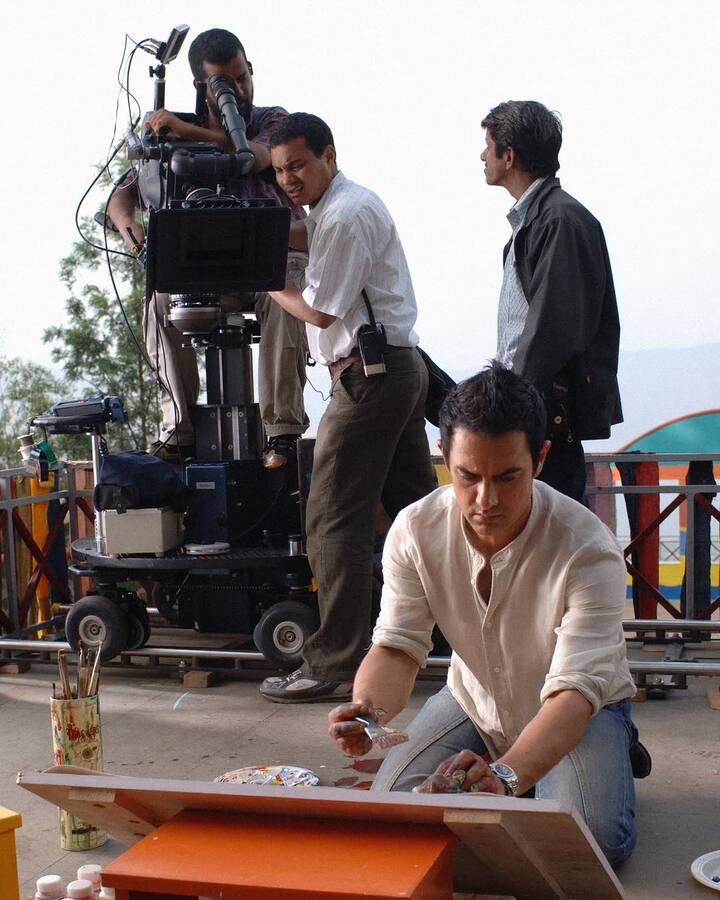 A memorable image captures Aamir Khan dressed for the popular Bum Bum Bole song from the film.