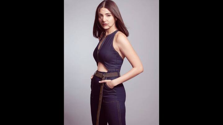 1. Edgy Denim Jumpsuit: Anushka Sharma looked stunning in this sleek and dark denim jumpsuit. The outfit had a bold cutout detail along with a front zipper. She styled her outfit with a statement belt that made the outfit a perfect blend of edgy and chic look. (Image Source: Instagram/@anushkasharma)