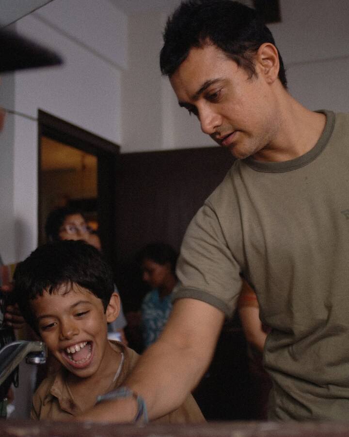 The BTS photos showcase Aamir Khan behind the camera, observing scenes, and interacting with Darsheel Safary.