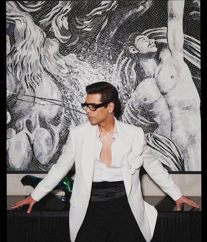 Draped in a sharp white blazer, KJo exudes an aura of refined elegance. The structured fit is elevated by a dramatic white floral embellishment on the lapel—an unconventional yet striking detail that immediately captures attention.