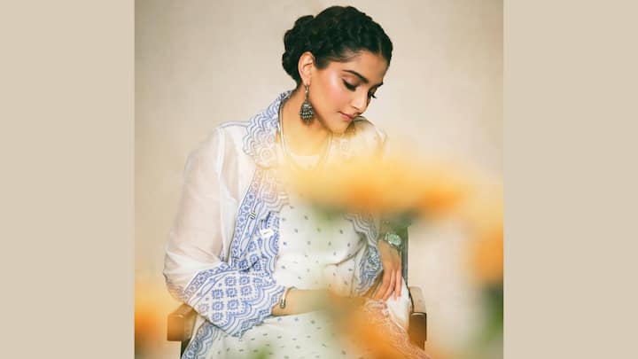 Sonam's blue-printed kurta with sheer full-length sleeves and scalloped borders is displaying its eternal charm. Paired with pretty palazzos and an embroidered dupatta, her oxidised silver jhumkas and layered necklaces lend this outfit a classic yet contemporary Eid appeal. (Image Source: Instagram/ sonamkapoor)