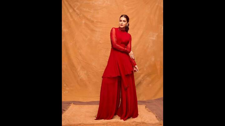 1. Bold Red Look: The striking red outfit with a high neck, full sleeve, and intricate embellishments exuded grace and confidence. Kriti Sanon paired her look with a layered palazzo pants that added a contemporary touch to her fit. The outfit made the actress look stunning, making it ideal for special occasions. (Image Source: Pinterest/southfashions)