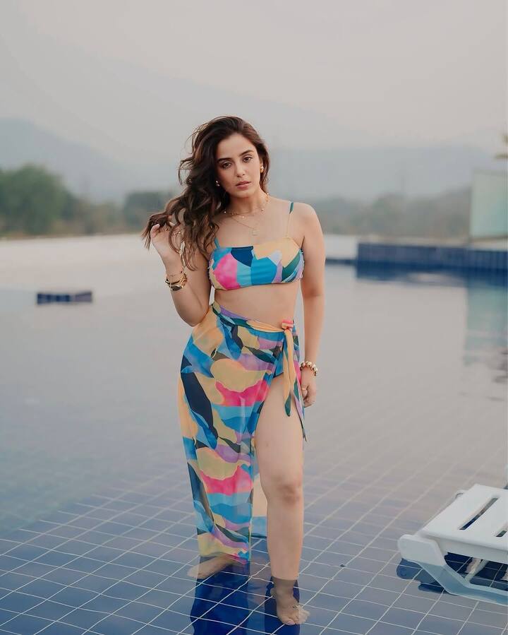 Bringing an artistic flair to her swimwear, Srishty rocked a colourful abstract noodle strap top paired with a matching wrap skirt.