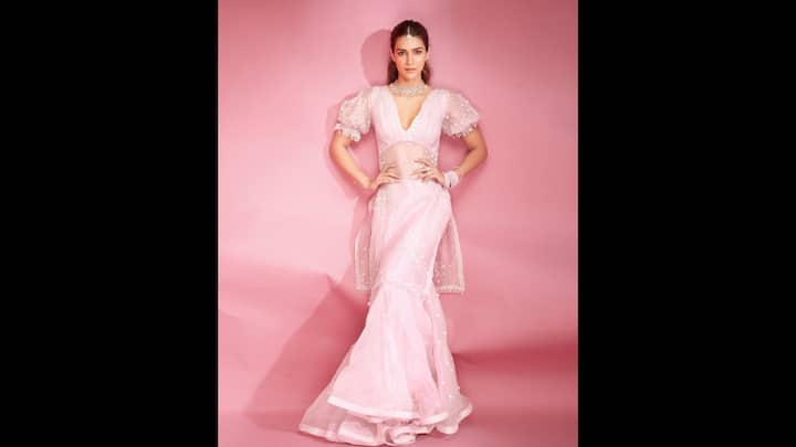 2. Dreamy Pink Look: This soft pink suit with sheer sleeves and delicate beadwork gave a unique look to Kriti Sanon. The actress exuded an ethereal charm in her fitted bodice and flowy bottom. The graceful silhouette is an elegant choice for contemporary ethnic fashion lovers. (Image Source: Instagram/@kritisanon)
