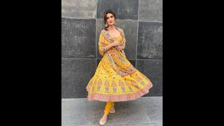 8. Vibrant Yellow Anarkali: Kriti Sanon wore a yellow Anarkali with floral prints and delicate embroidery. She paired her outfit with a matching dupatta and churidar. The ethnic outfit is a go-to choice for any stylish yet comfortable look. (Image Source: Instagram/@kritisanon)