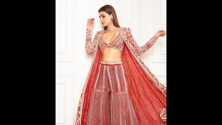 5. Red Three Piece Suit: Kriti Sanon wore a bold red three piece sharara set that featured a structured jacket, matching blouse, and flared pants. The ethnic outfit had intricate geometric embroidery and a deep neckline that blended tradition with modern styles. (Image Source: Instagram/@kritisanon)