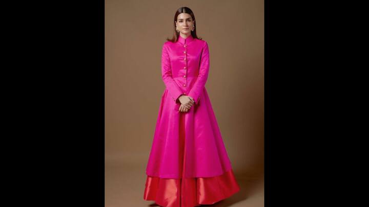 7. Pink Indo-Western Suit: Kriti Sanon's pink Indo-western look exuded royalty with its structured silhouette. The bold pink look featured a high neck design and golden buttons. The flared hem of the suit made it a statement piece that's ideal for Eid celebrations. (Image Source: Pinterest/vogueindia)