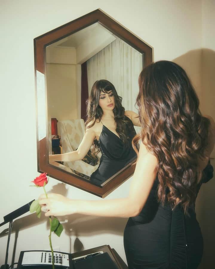 Her confident and poised expressions bring out a sultry yet classy aura, perfectly fitting the mood of the photoshoot.